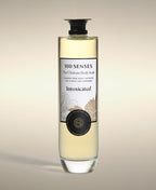 Intoxicated Ultimate Body Soak in a thick-bottomed glass bottle with botanical label artwork.