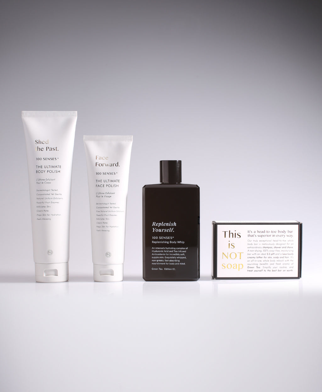 Body polish, face polish, body whip and a This Is Not Soap Ultimate Body Bar arranged together.