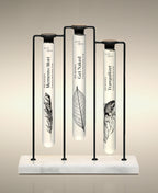 Memento Mori, Get Naked and Tranquilizer glass Foaming Cylinder Soaks displayed in the Trio Cylinder Soak Stand in black-and-marble.