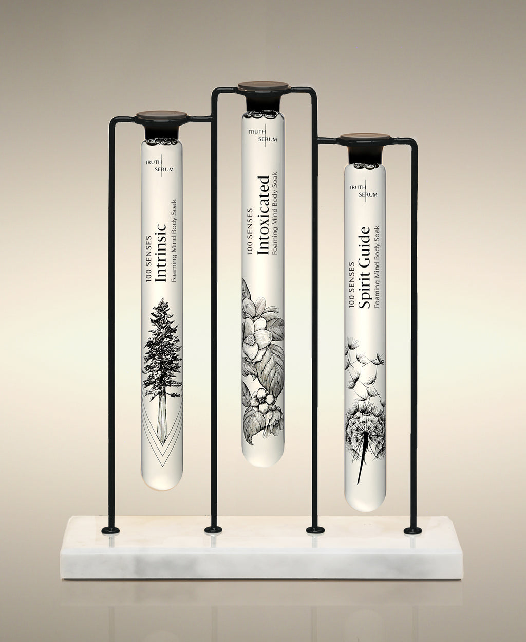 Intrinsic, Intoxicated and Spirit Guide  glass Foaming Cylinder Soaks displayed in the Trio Cylinder Soak Stand in black-and-marble.