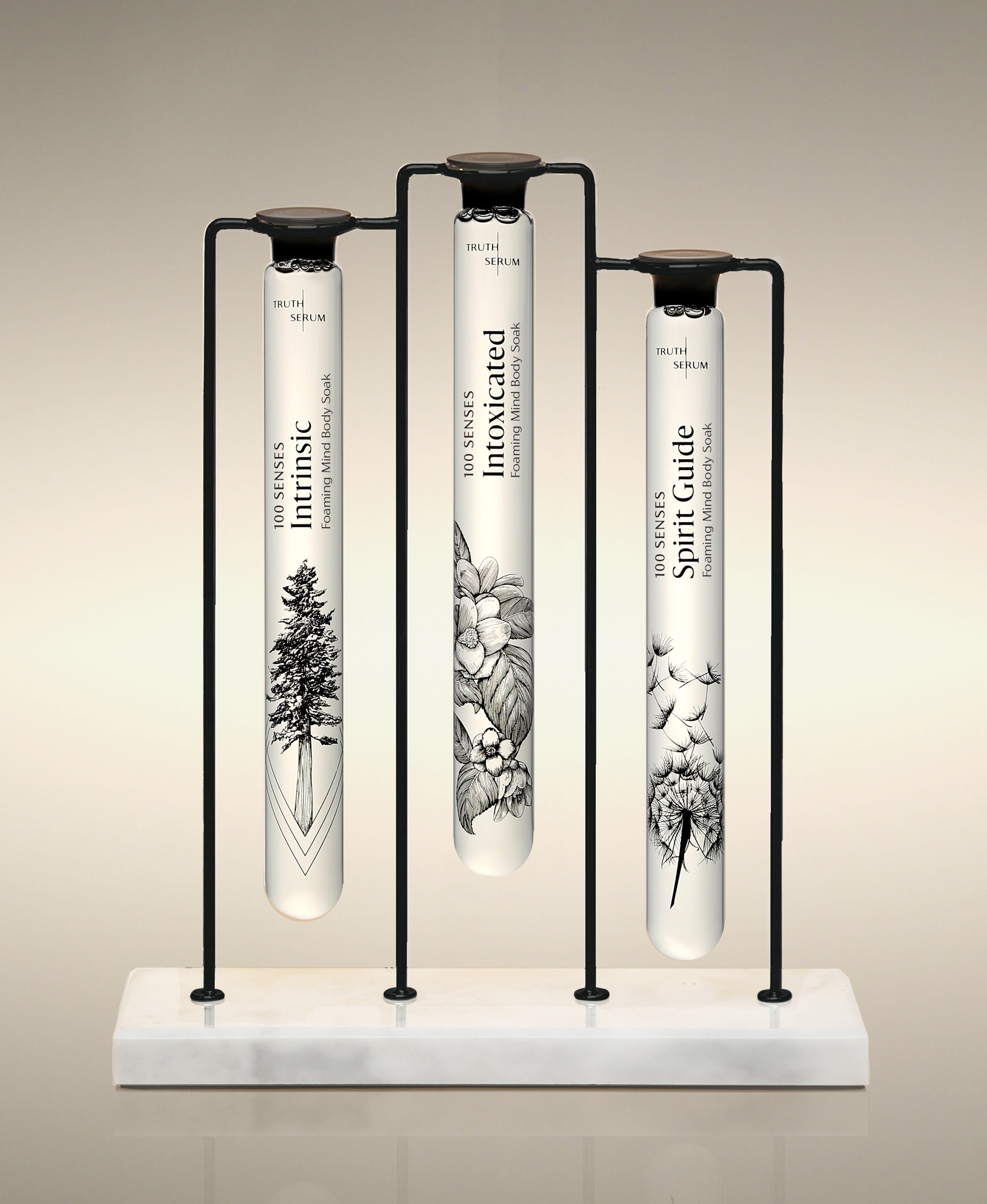 Intrinsic, Intoxicated and Spirit Guide  glass Foaming Cylinder Soaks displayed in the Trio Cylinder Soak Stand in black-and-marble.
