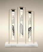 Memento Mori, Get Naked and Tranquilizer glass Foaming Cylinder Soaks displayed in the Trio Cylinder Soak Stand in gold-and-marble.