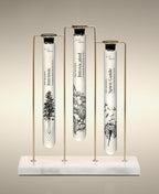 Intrinsic, Intoxicated and Spirit Guide  glass Foaming Cylinder Soaks displayed in the Trio Cylinder Soak Stand in gold-and-marble.
