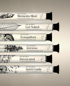Memento Mori, Get Naked, Tranquilizer, Intrinsic, Intoxicated and Spirit Guide Foaming Cylinder Soaks in glass bottles, stacked horizontally.