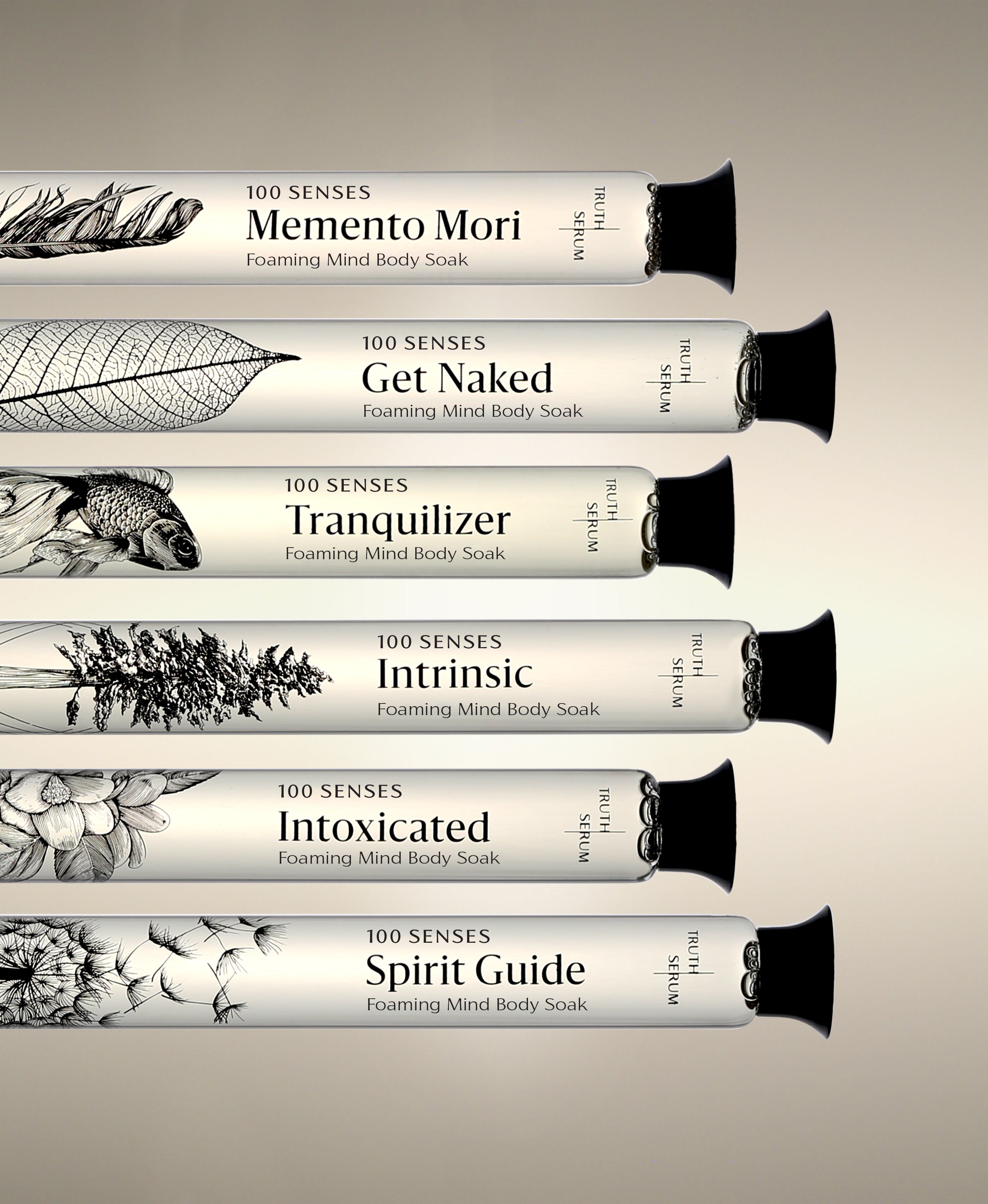 Memento Mori, Get Naked, Tranquilizer, Intrinsic, Intoxicated and Spirit Guide Foaming Cylinder Soaks in glass bottles, stacked horizontally.