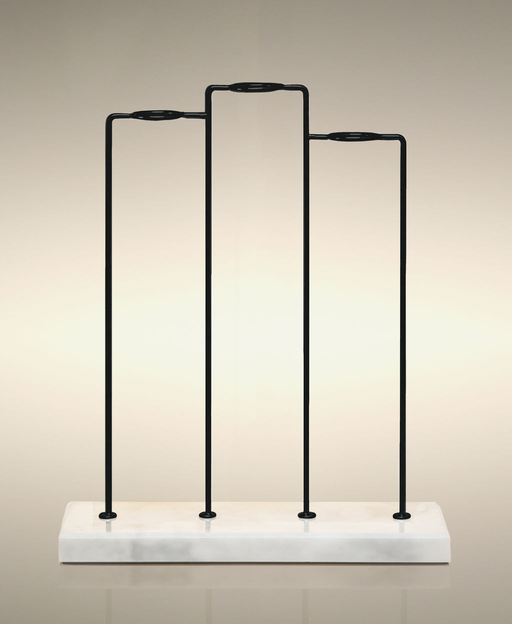 Empty Trio Cylinder Soak Stand with black metal frame and solid white marble base.