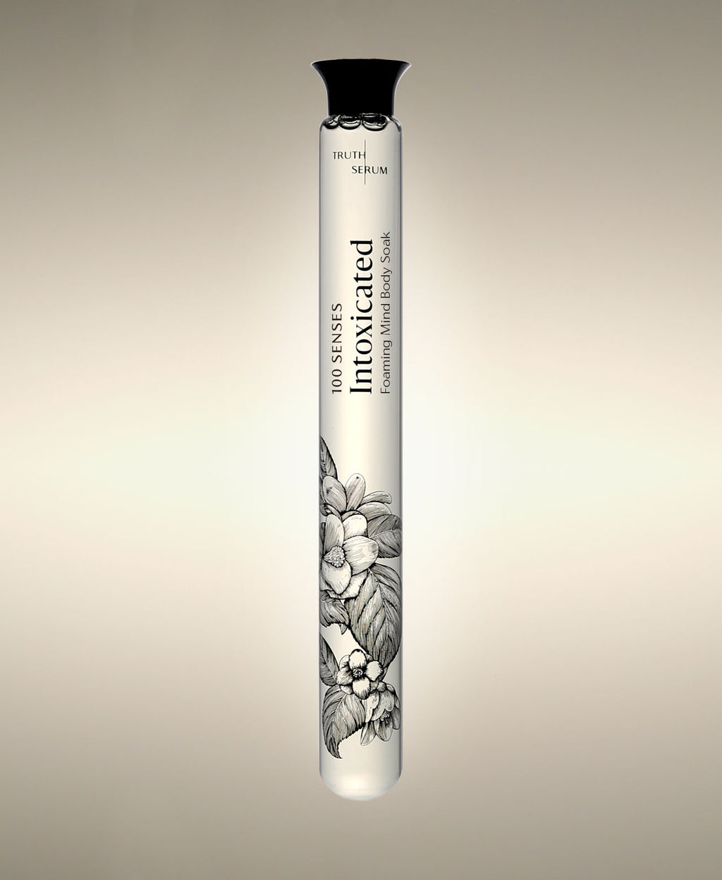 Intoxicated Foaming Bath Soak glass cylinder with a floral illustration, standing against a warm neutral background.