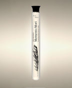 Memento Mori Wild Fig glass Foaming Cylinder Soak with feather illustration, standing against a warm neutral background.