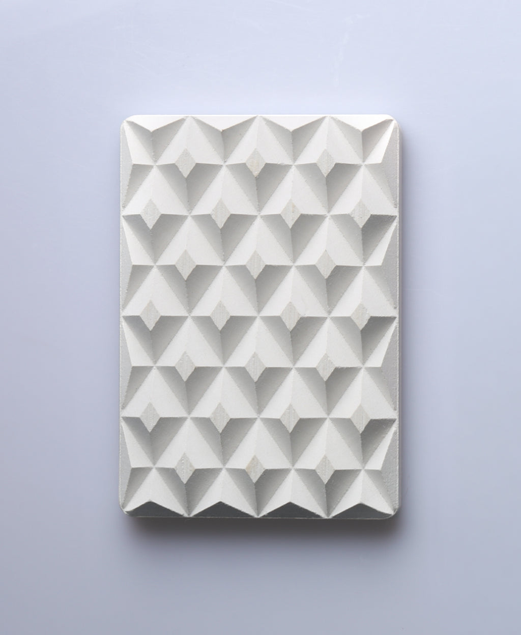 Natural white 3D Pyramid Body Bar Rest with a faceted pyramid pattern.