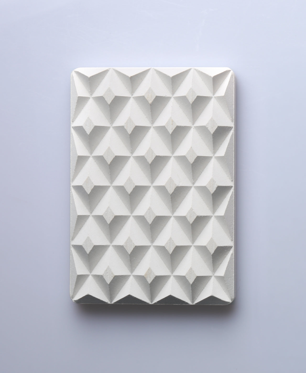 Natural white 3D Pyramid Body Bar Rest with a faceted pyramid pattern.