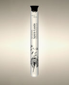 Spirit Guide Vetiver Agarwood glass Foaming Cylinder Soak with an illustration of dandelion seeds drifting from the seed head, standing against a warm neutral background.