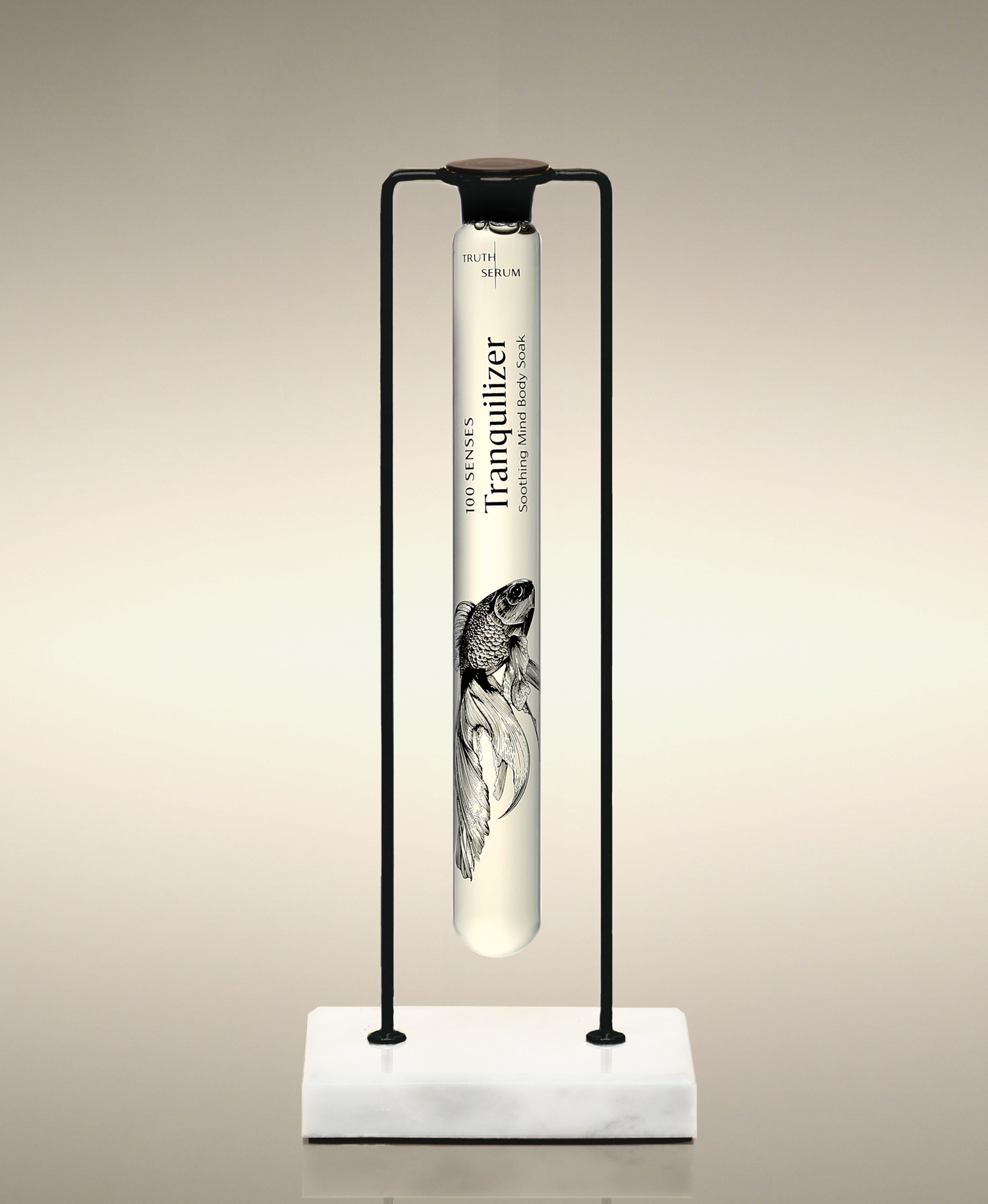 Tranquilizer glass Foaming Cylinder Soak displayed in the Single Cylinder Soak Stand in black-and-marble