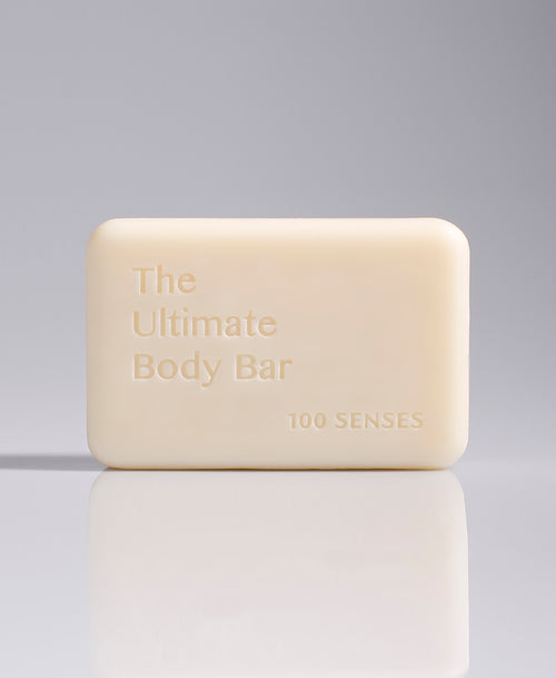 The Ultimate Body Bar standing upright against a pale gray gradient background.