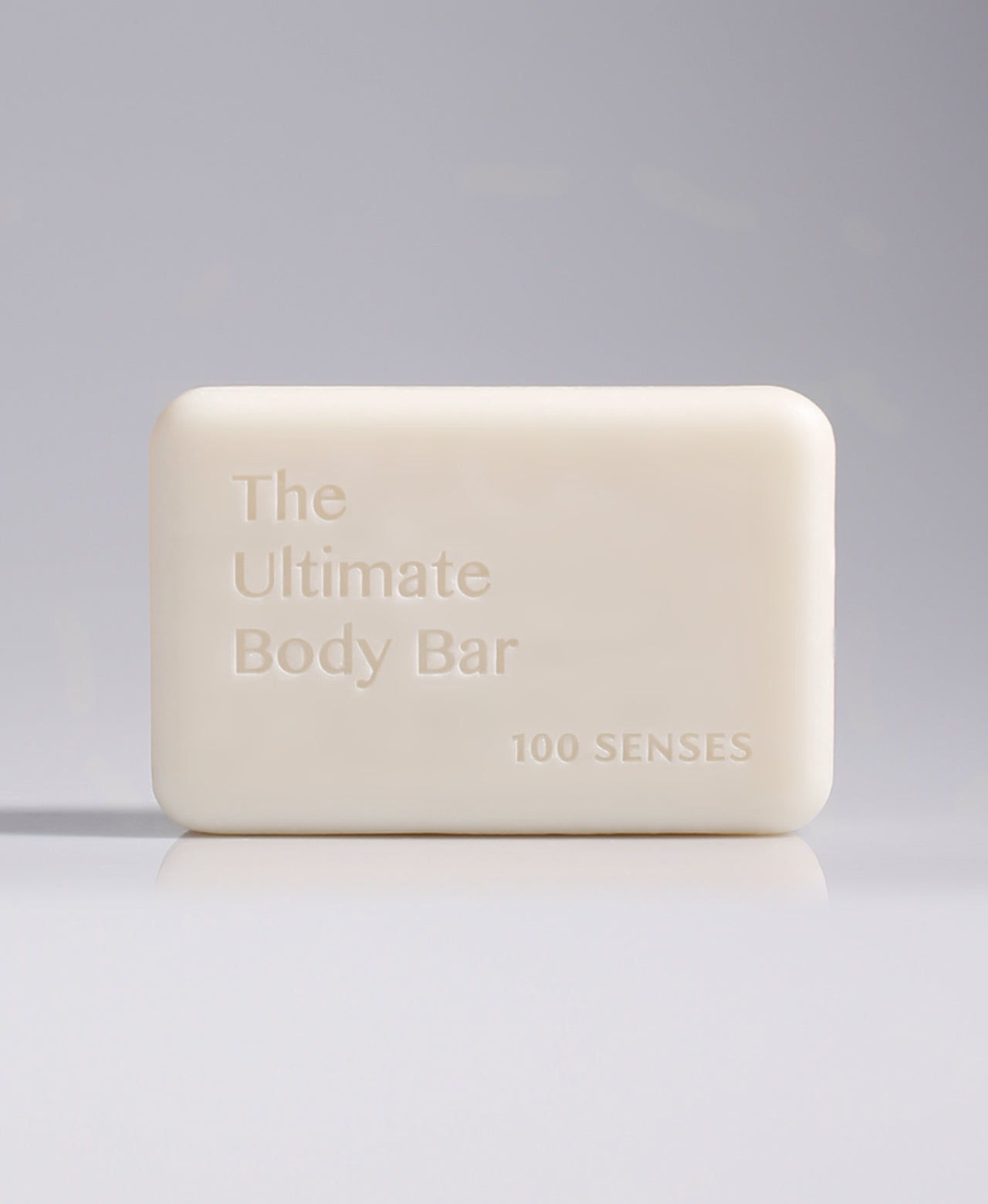 The Ultimate Body Bar standing upright against a pale gray gradient background.