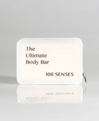 A rectangular TPU body bar travel case labeled 'The Ultimate Body Bar' and '100 SENSES' on a light gray background with a soft reflection below.