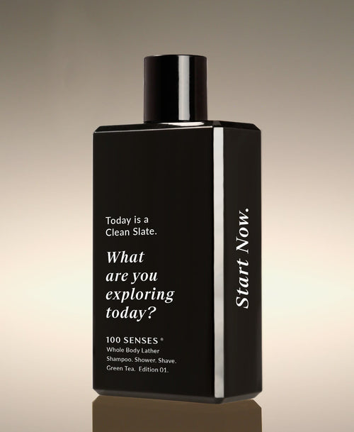 Clean Slate Body Lather Green Tea bottle angled beside its carton, reading “What are you exploring today?” on the front and “Start Now.” on the side.