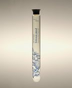 Intoxicated White Tuberose Soothing Cylinder Bath Oil glass cylinder with floral line-art illustration.