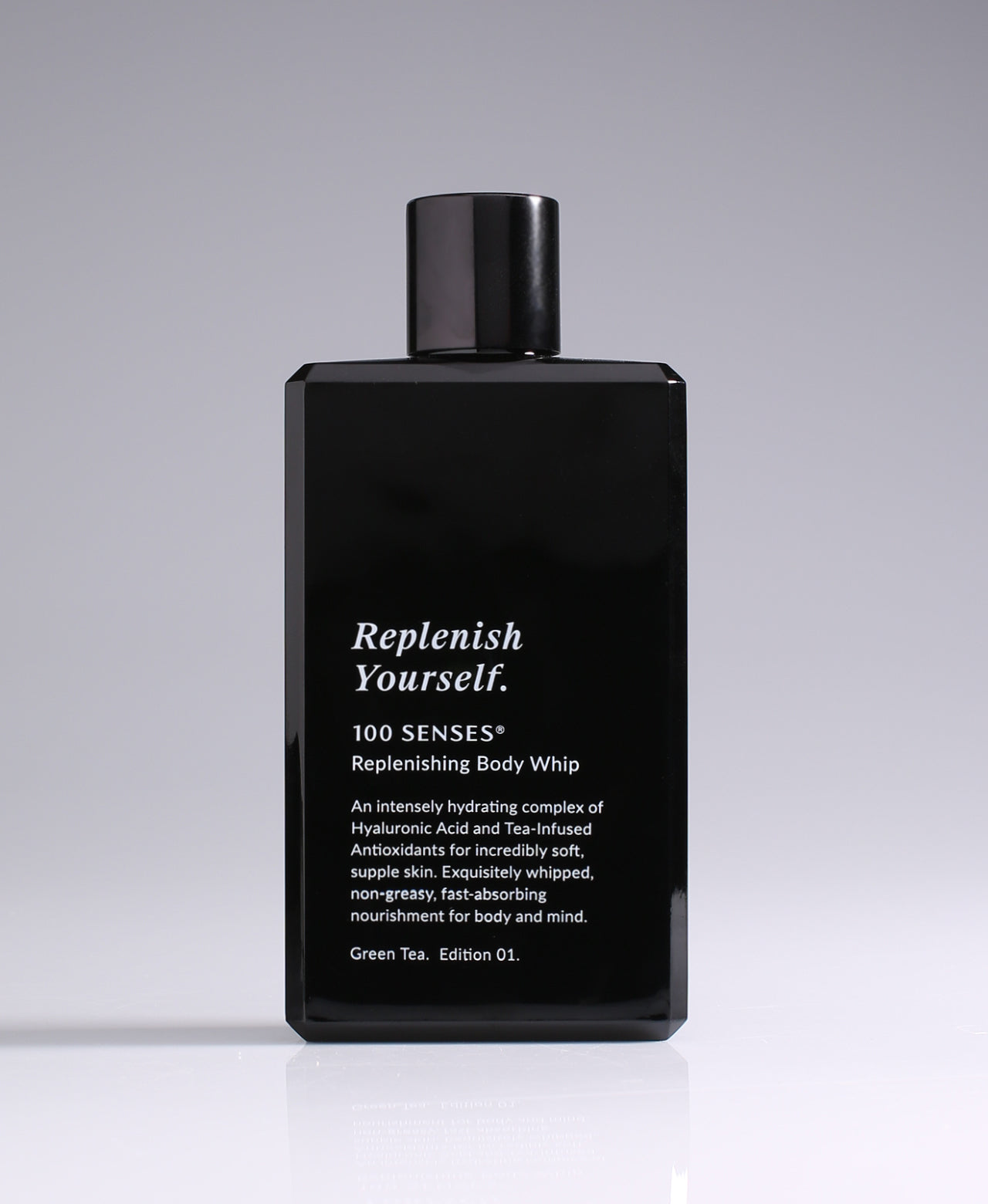 Replenish Yourself Body Whip bottle standing against a pale gradient gray background.