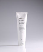 Face Forward Ultimate Face Polish tube standing against a pale gradient gray background.