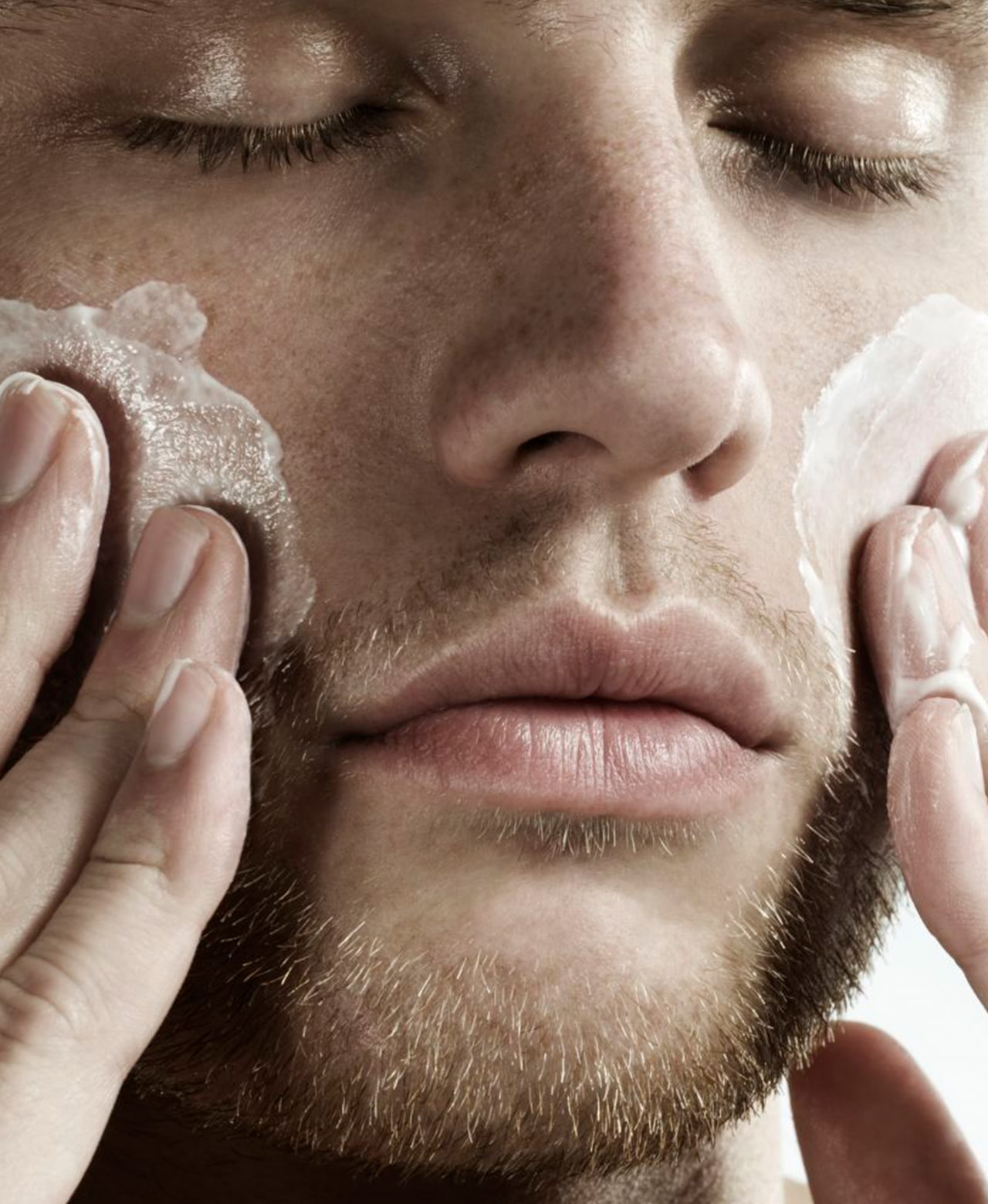 Person massaging Face Forward Ultimate Face Polish over their cheeks.