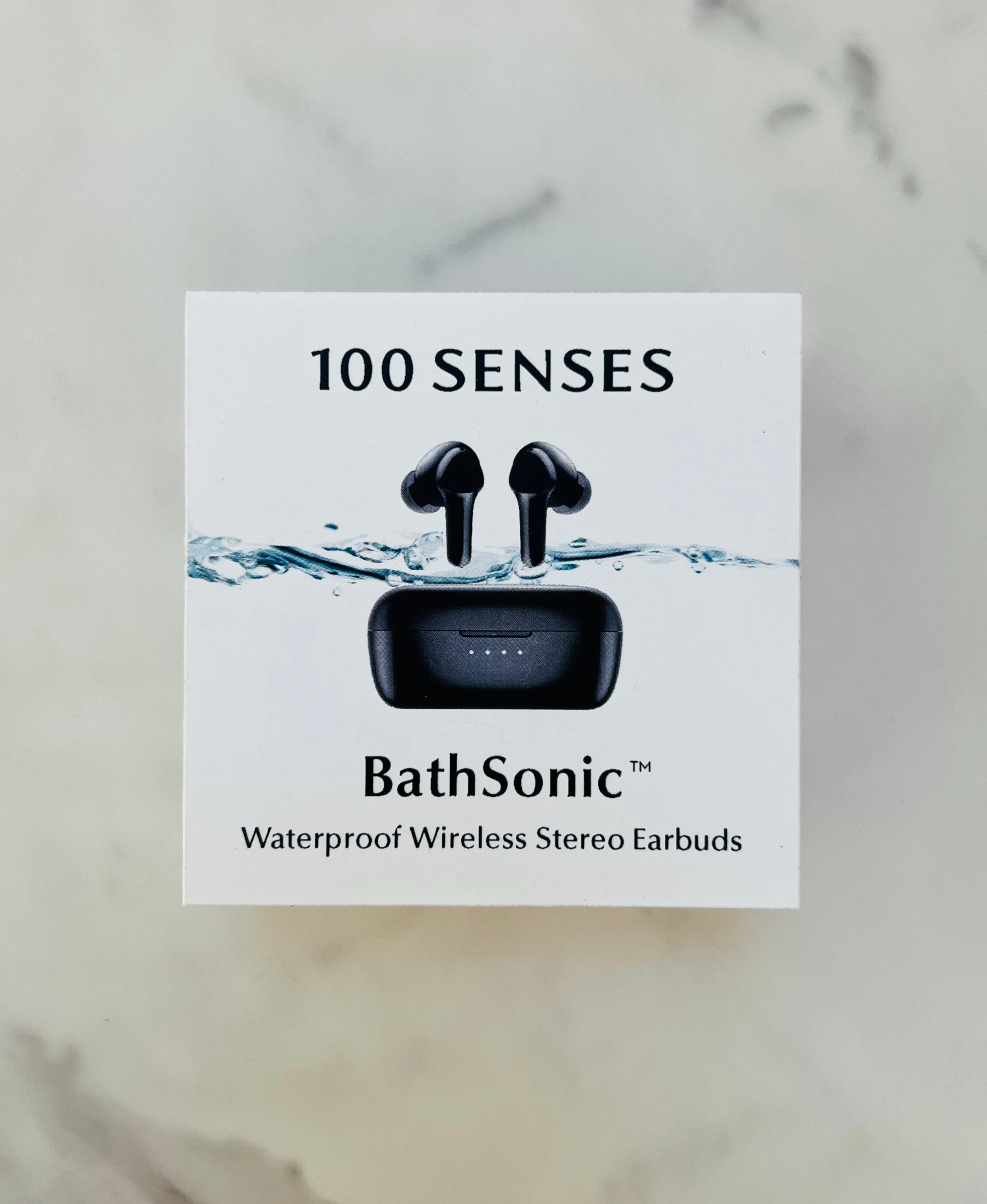 BathSonic waterproof earbuds and charging case pictured on product packaging.