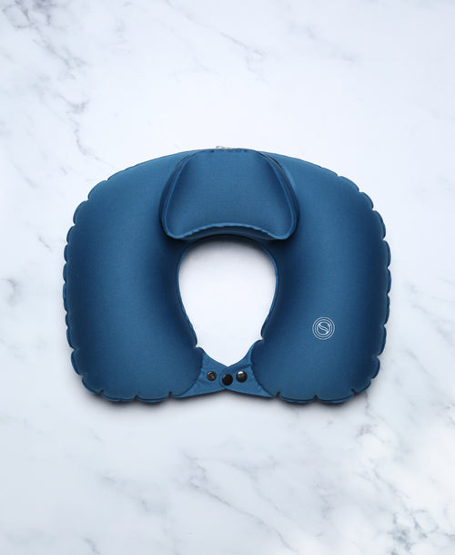 Blue U-shaped Head Floater bath pillow shown from the front on white marble.