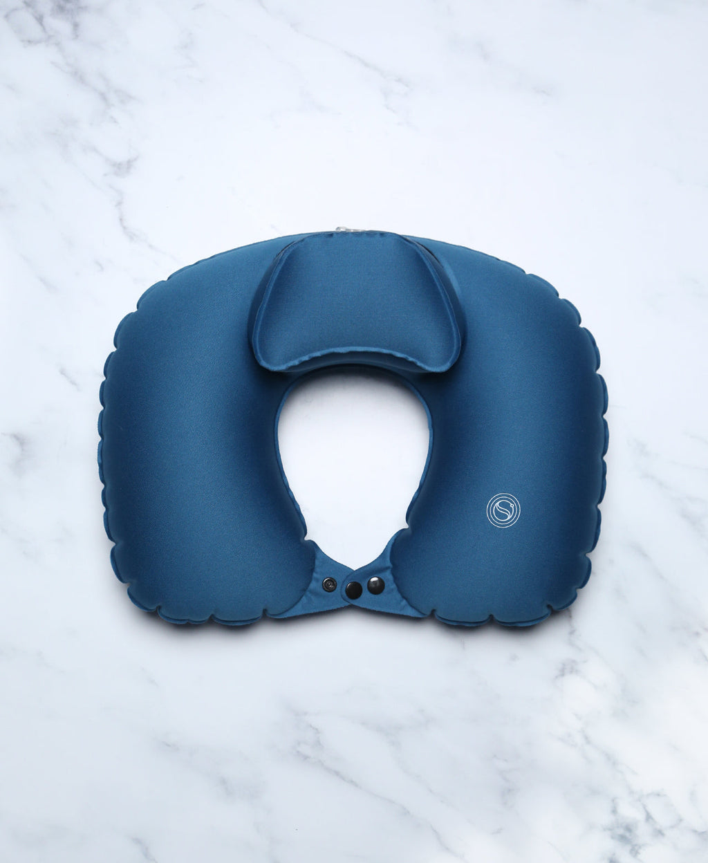 Blue U-shaped Head Floater bath pillow on white marble.