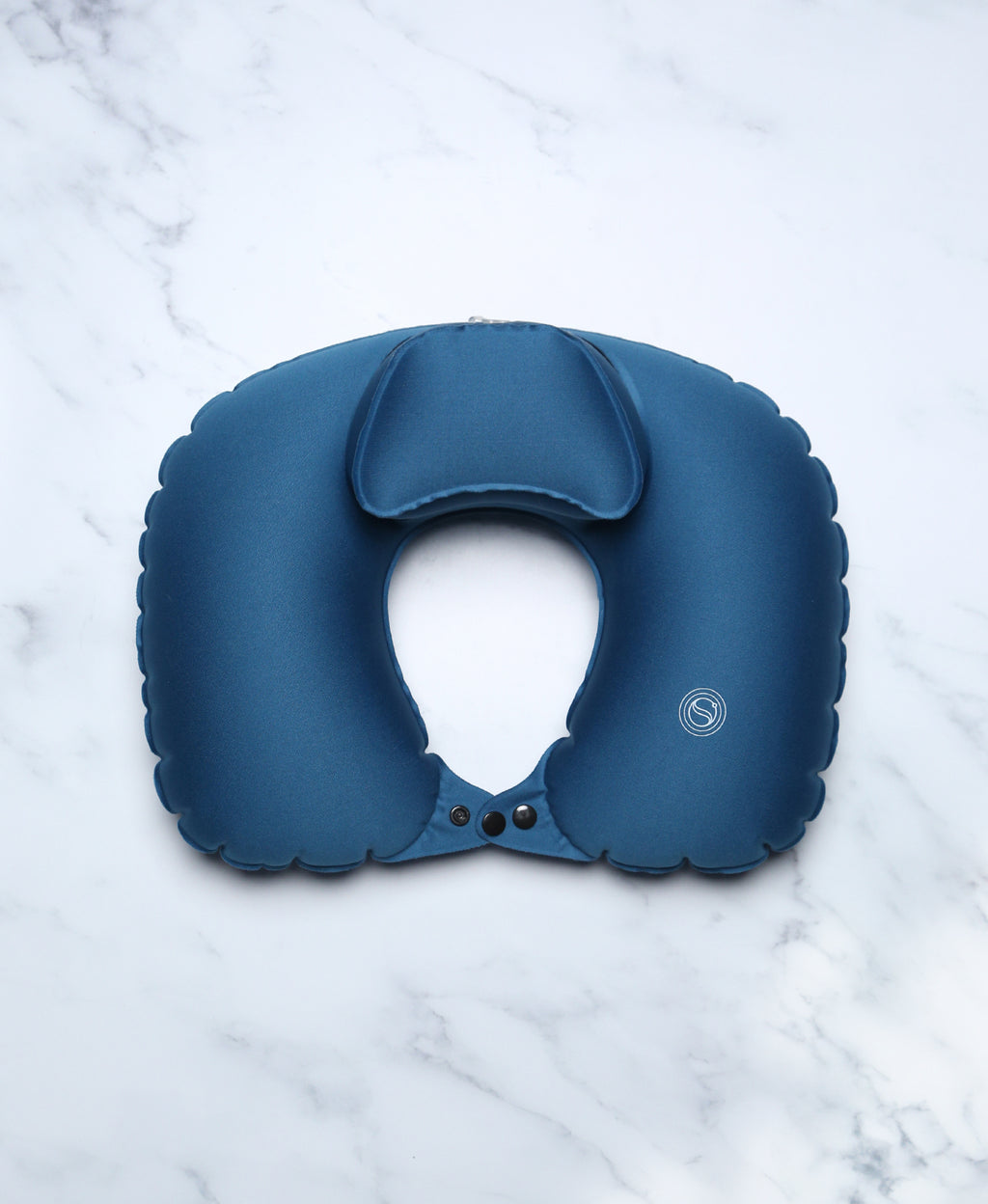 Blue U-shaped Head Floater bath pillow viewed from above on white marble.