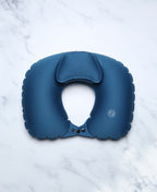 Blue U-shaped Head Floater bath pillow on white marble.