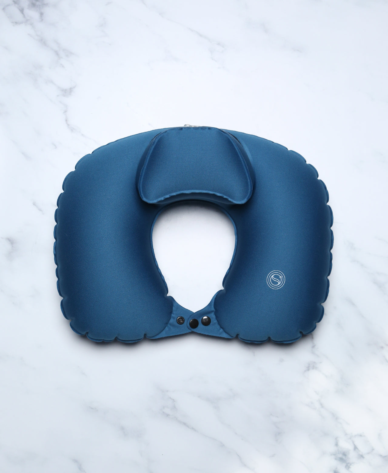 Blue U-shaped Head Floater bath pillow on white marble.