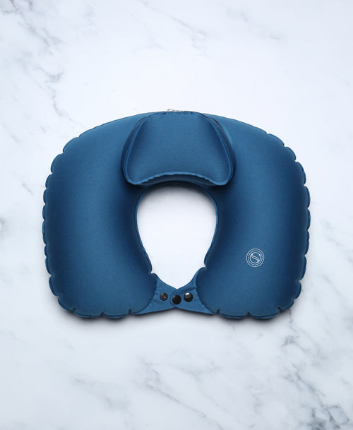 Blue U-shaped Head Floater bath pillow snapped closed on white marble.