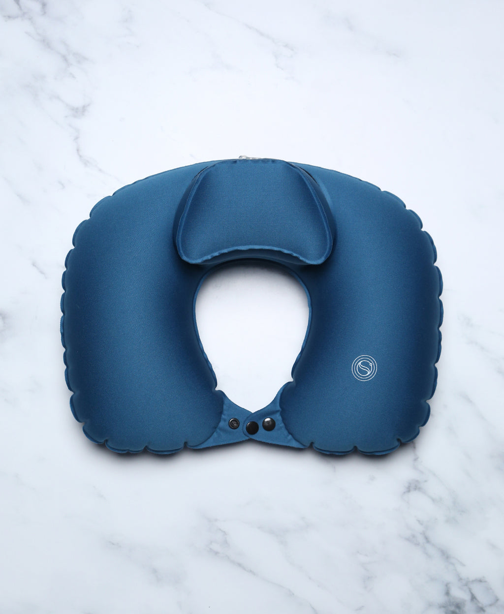 Blue U-shaped Head Floater bath pillow snapped closed on white marble.