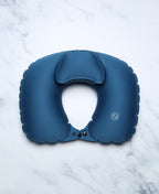 Blue U-shaped Head Floater bath pillow snapped closed on white marble.