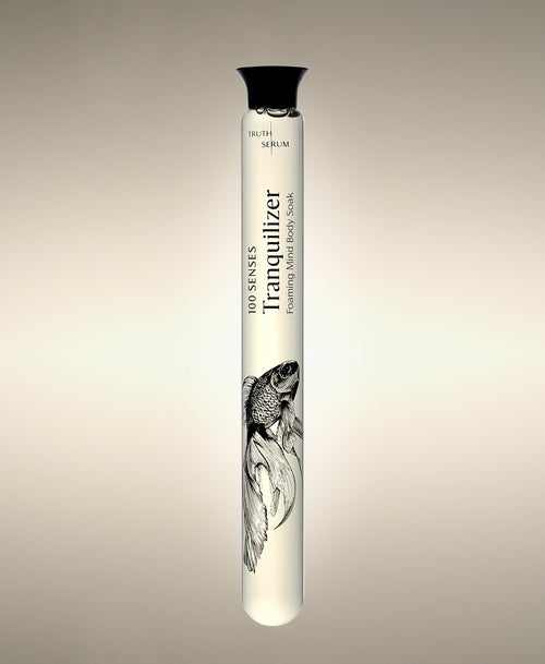 Tranquilizer Foaming Bath Soak glass cylinder with betta fish illustration.