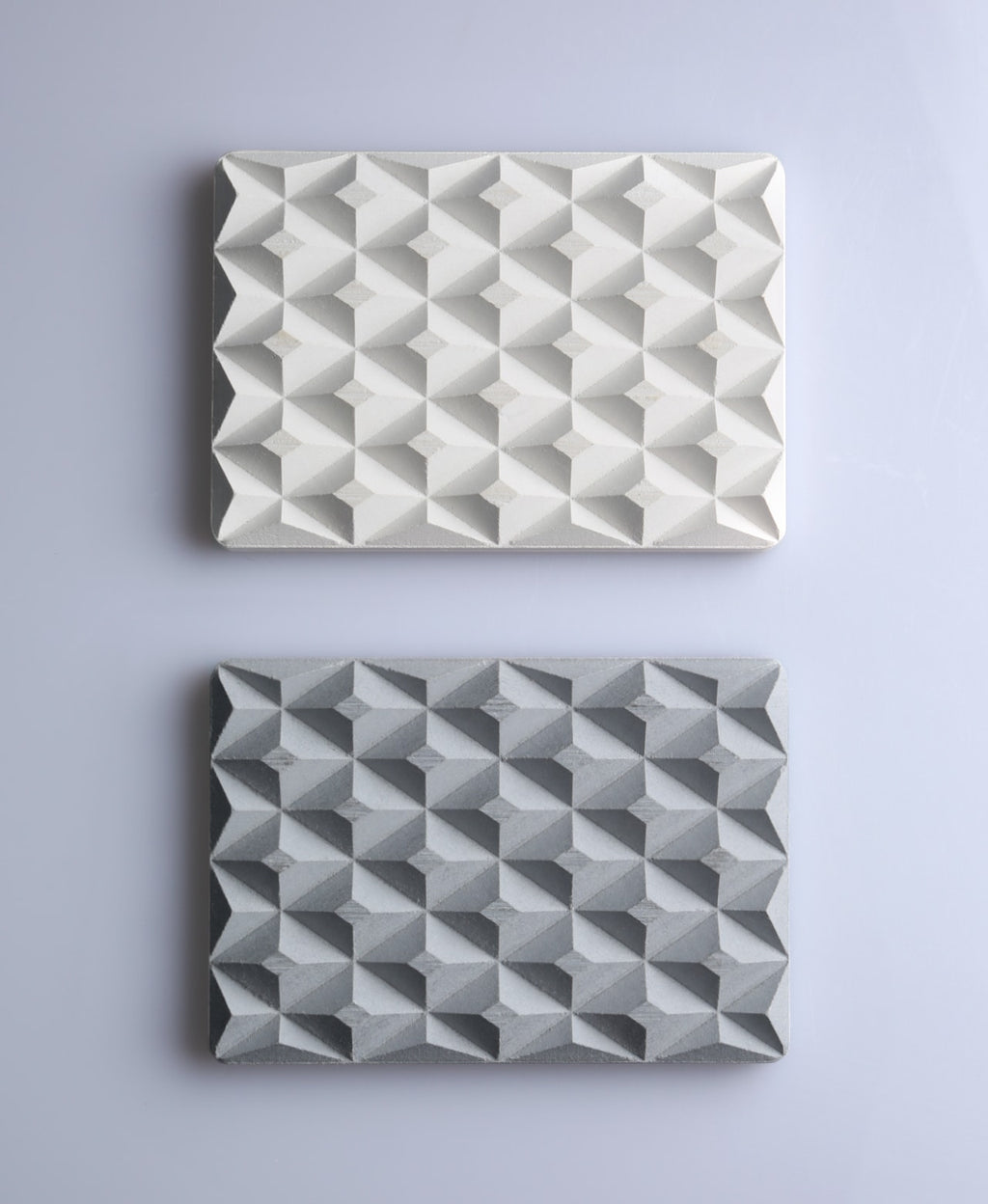 Natural white and stone gray 3D Pyramid Body Bar Rests with faceted pyramid patterns on gray.