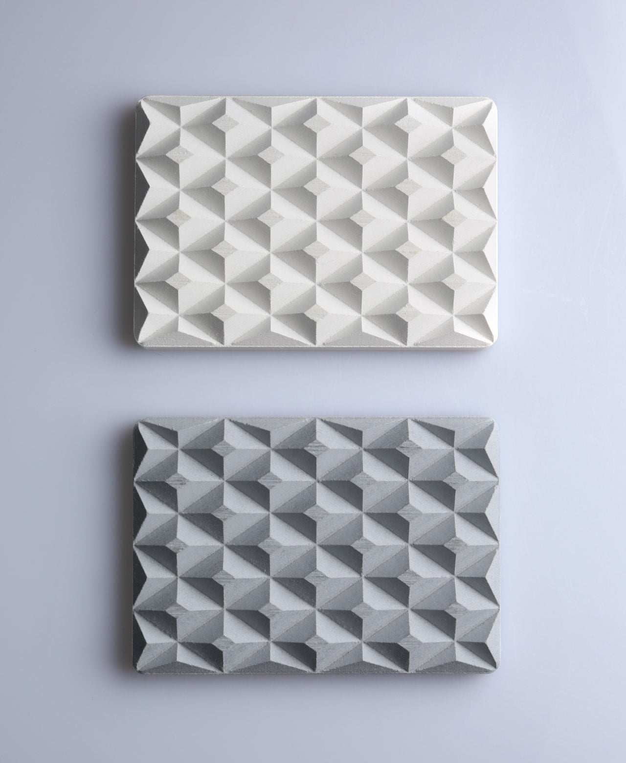 Natural white and stone gray 3D Pyramid Body Bar Rests with faceted pyramid patterns on gray.