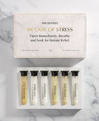 In Case of Stress Mind/Body Soak Sampler with six assorted single-use Foaming Bath Soaks in glass cylinders.