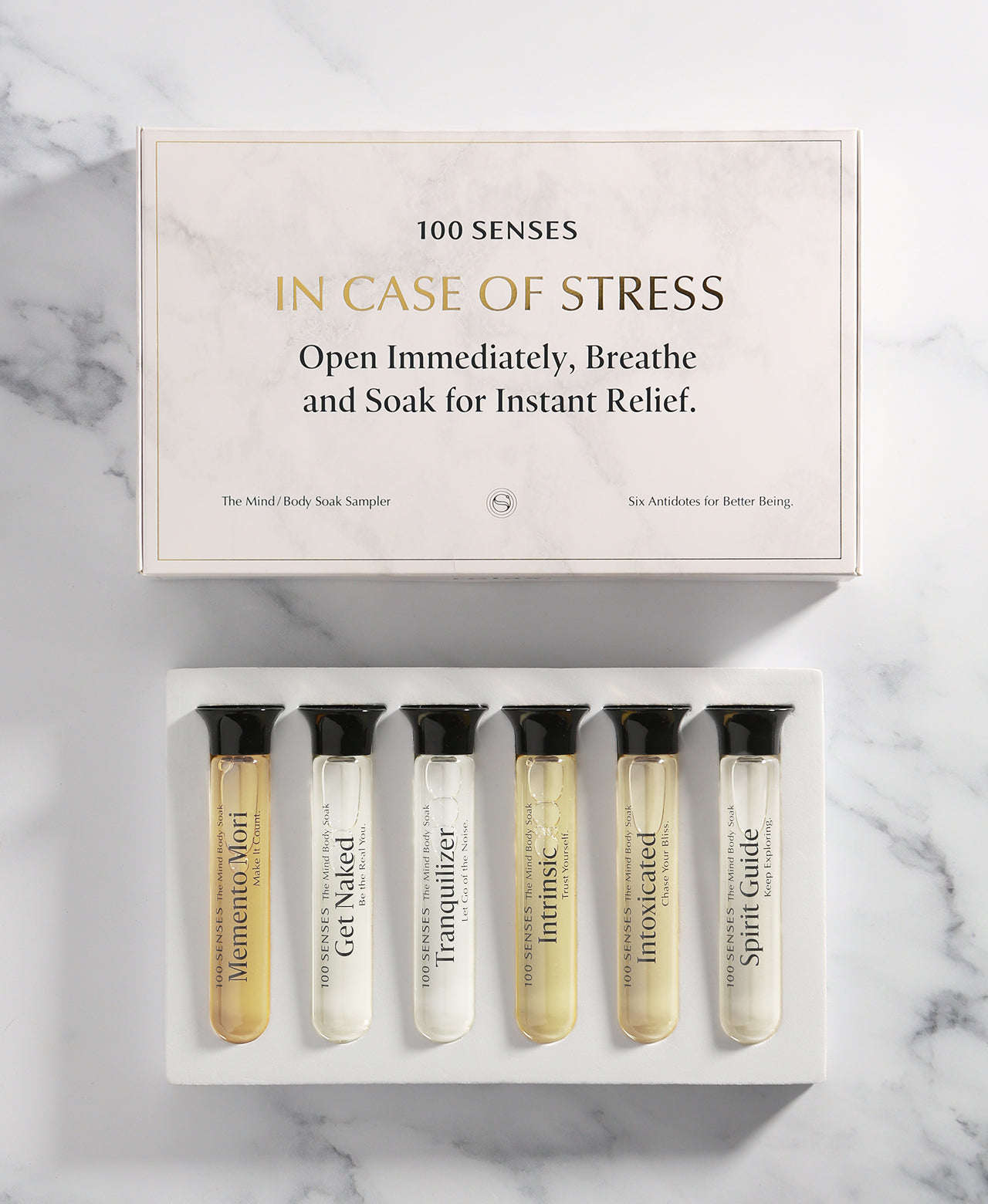 In Case of Stress Mind/Body Soak Sampler with six assorted single-use Foaming Bath Soaks in glass cylinders.