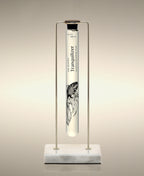 Tranquilizer glass Foaming Cylinder Soak displayed in a gold metal stand on a marble base.