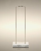 Empty gold metal glass Cylinder Soak stand on a marble base.