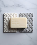 The Ultimate Body Bar resting across natural white and stone gray 3D Pyramid Bar Rests.