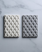 Natural white and stone gray 3D Pyramid Body Bar Rests with faceted pyramid patterns on marble.