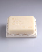 Ultimate Body Bar resting on a white geometric 3D Pyramid Body Bar Rest.